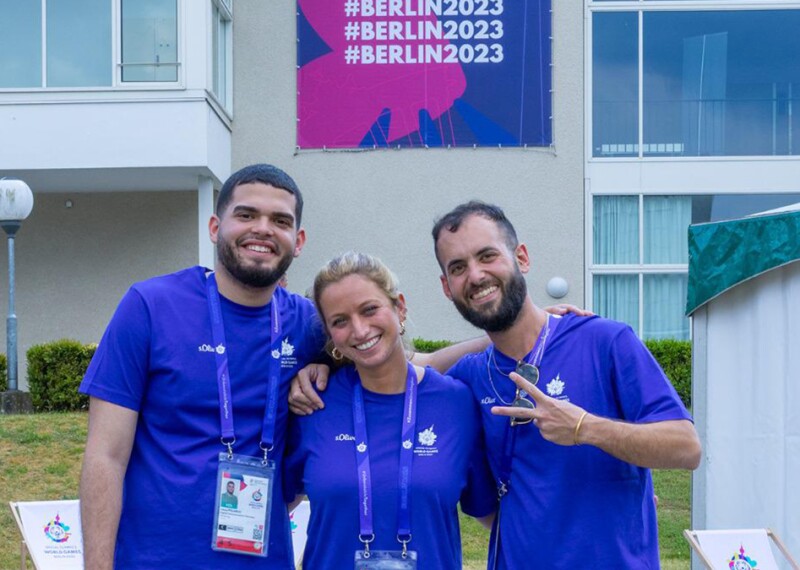 Members of the accessiBe delegation pose for a photo together in front of Berlin 2023 signage.