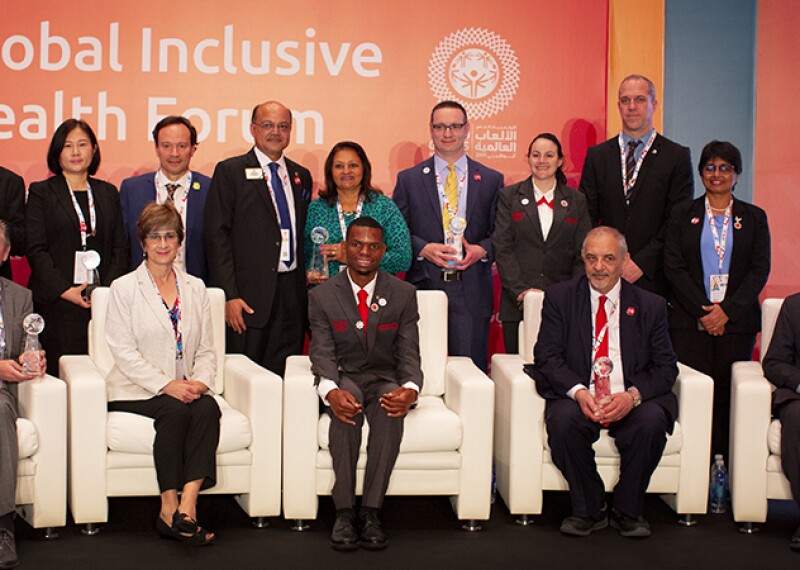 Golisano Global Health Leadership Awards recipients seated on stage: Ms. Ann Costello, Executive Director, Golisano Foundation and Nyasha Derera and Ibtihaj Muhammad both Sargent Shriver International Global Messenger at the Global Health Forum.↵↵Recipients include: Professor Kamal Bani-Hani of Jordan, Dr. Luc Marks of Belgium, Ying Feng from Hua Dong Hospital in China, Dr. Ashok Dhoble of India, Dr. Manoj Shah from The Lions Sight First Eye Hospital in Kenya, Marco Villasboa, Chairmen of the board of Special Olympics Paraguay, is accepting the award on Dr. Ferreira’s behalf, Dr. Peter Seidenberg from the United States of America.