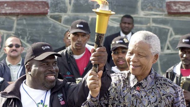 Ricardo Thornton and Nelson Mandella holding the Flame of Hope together. 